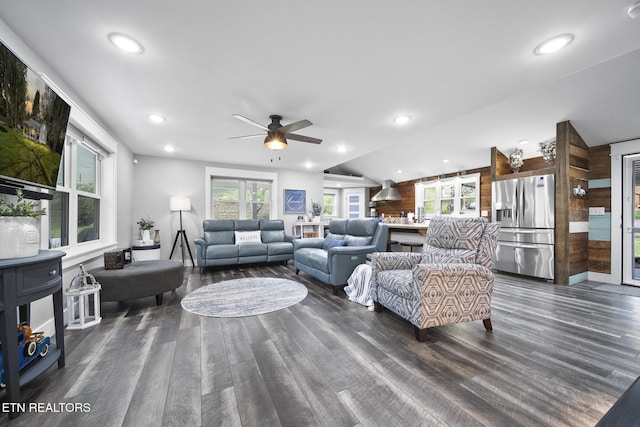 living area featuring lofted ceiling, a ceiling fan, dark wood-type flooring, and recessed lighting