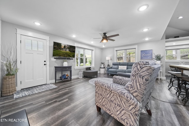 living area with dark wood finished floors, plenty of natural light, and a ceiling fan