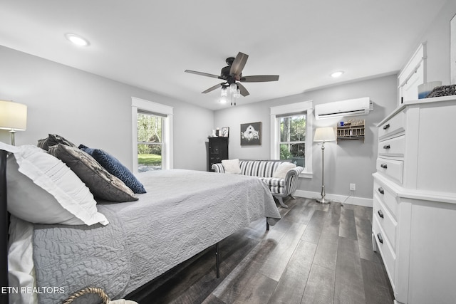bedroom with a wall mounted air conditioner, multiple windows, dark wood-type flooring, and recessed lighting