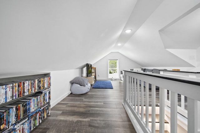 interior space with lofted ceiling, baseboards, wood finished floors, and recessed lighting