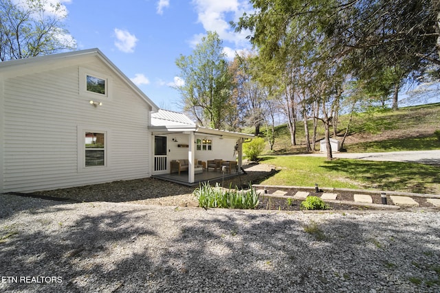 rear view of house with metal roof