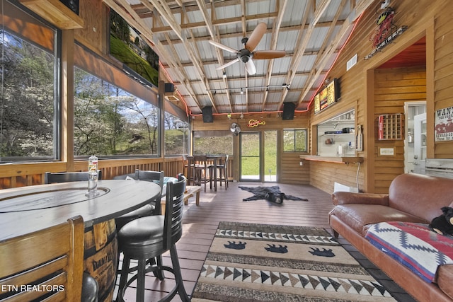 sunroom featuring ceiling fan