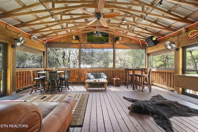 sunroom with outdoor dining area, outdoor lounge area, and ceiling fan