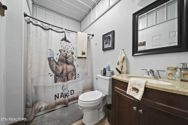 full bathroom featuring toilet, vanity, wood finished floors, and curtained shower