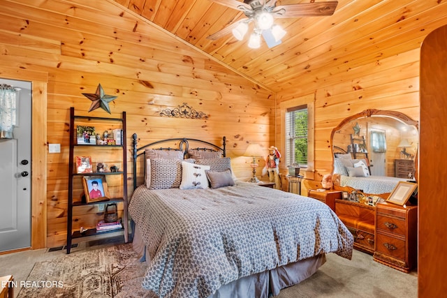 carpeted bedroom with wood walls, vaulted ceiling, and wood ceiling