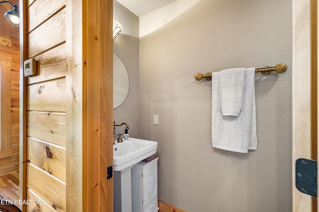 half bath featuring wood finished floors