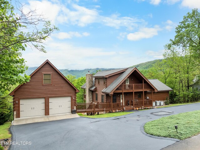 log home with a chimney and log siding