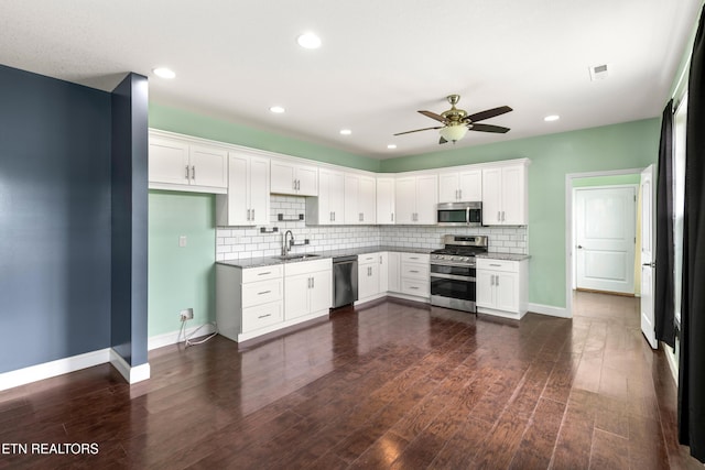 283 Red Hill Rd, Andersonville, TN 37705 - kitchen featuring stainless steel appliances, a sink, a ceiling fan, light stone countertops, and decorative backsplash