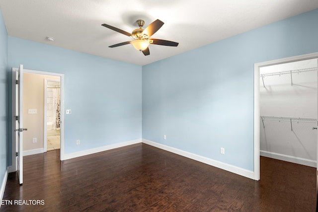 283 Red Hill Rd, Andersonville, TN 37705 - unfurnished bedroom with a walk in closet, wood finished floors, baseboards, a closet, and a ceiling fan