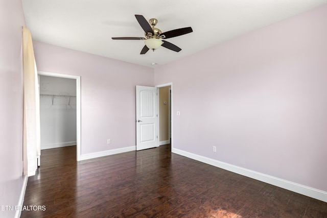 283 Red Hill Rd, Andersonville, TN 37705 - unfurnished bedroom featuring baseboards, dark wood finished floors, a spacious closet, and a closet