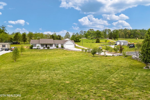 283 Red Hill Rd, Andersonville, TN 37705 - view of grassy yard with an attached garage and concrete driveway