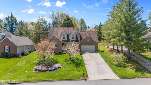 cape cod house with a garage, driveway, and a front lawn
