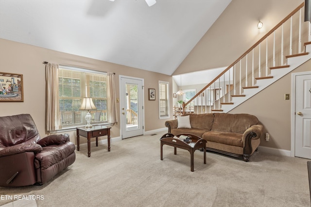 living room featuring stairway, carpet floors, a ceiling fan, and baseboards