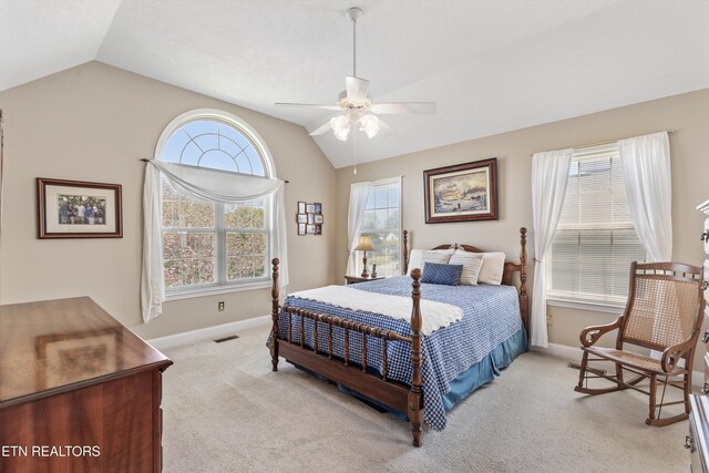 bedroom with vaulted ceiling, visible vents, baseboards, and light carpet