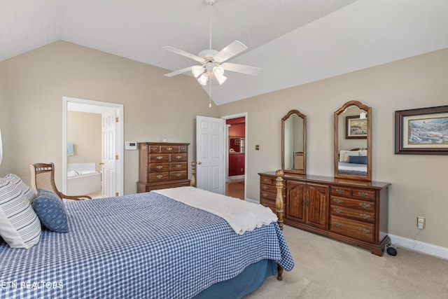 bedroom featuring vaulted ceiling, ensuite bathroom, ceiling fan, light colored carpet, and baseboards