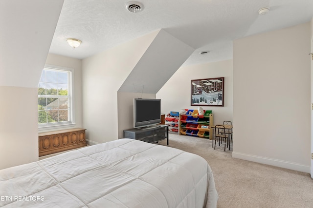 bedroom featuring carpet floors, vaulted ceiling, visible vents, and baseboards