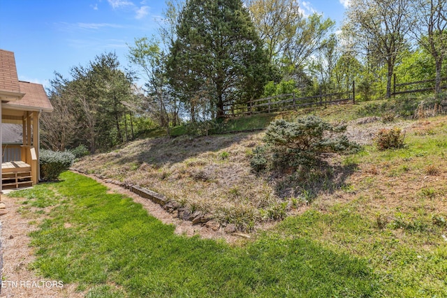view of yard with a wooden deck and fence