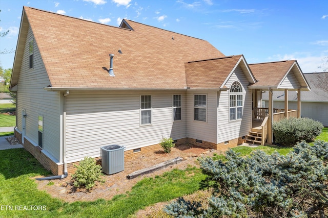 rear view of house with crawl space, a shingled roof, and central AC unit