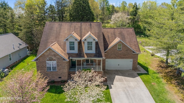 cape cod home featuring central AC unit, concrete driveway, a porch, brick siding, and a garage