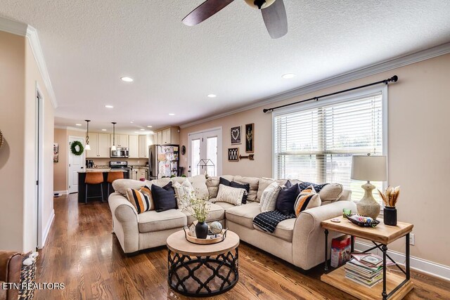 living area featuring a ceiling fan, crown molding, dark wood-style floors, and recessed lighting