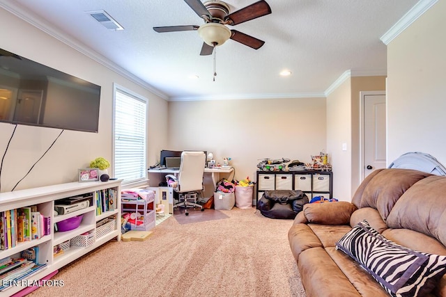 recreation room with a ceiling fan, ornamental molding, carpet flooring, and visible vents