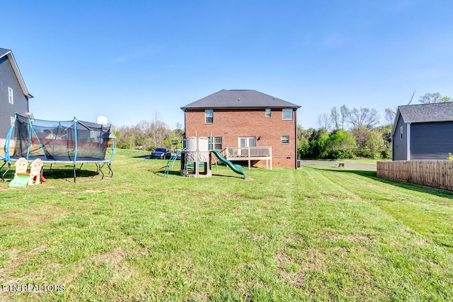view of yard with a playground and a trampoline