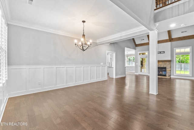 1416 Ebenezer Rd, Knoxville, TN 37922 - unfurnished living room with a wainscoted wall, a stone fireplace, wood finished floors, and a chandelier