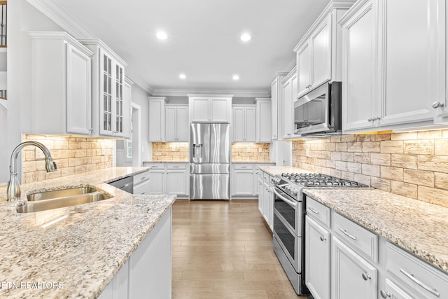 1416 Ebenezer Rd, Knoxville, TN 37922 - kitchen with appliances with stainless steel finishes, tasteful backsplash, a sink, recessed lighting, and white cabinetry
