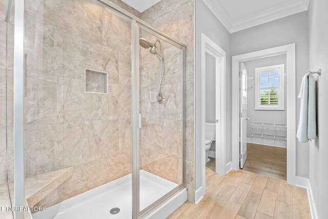 1416 Ebenezer Rd, Knoxville, TN 37922 - bathroom with ornamental molding, wood finished floors, toilet, baseboards, and a shower stall