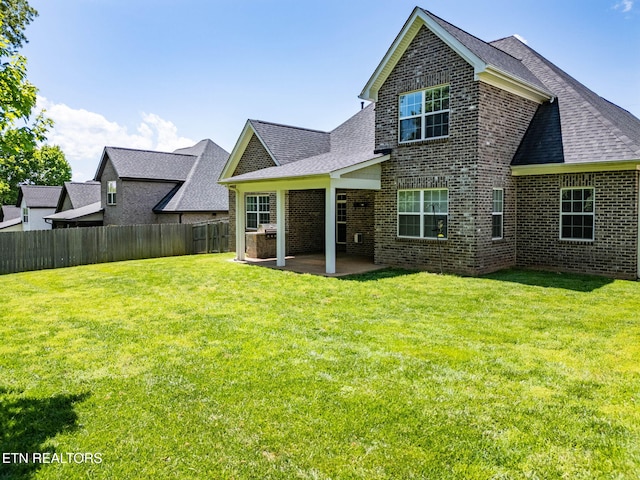 1416 Ebenezer Rd, Knoxville, TN 37922 - rear view of property with fence, a patio, roof with shingles, brick siding, and a lawn