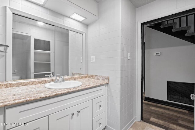 bathroom with vanity and wood finished floors