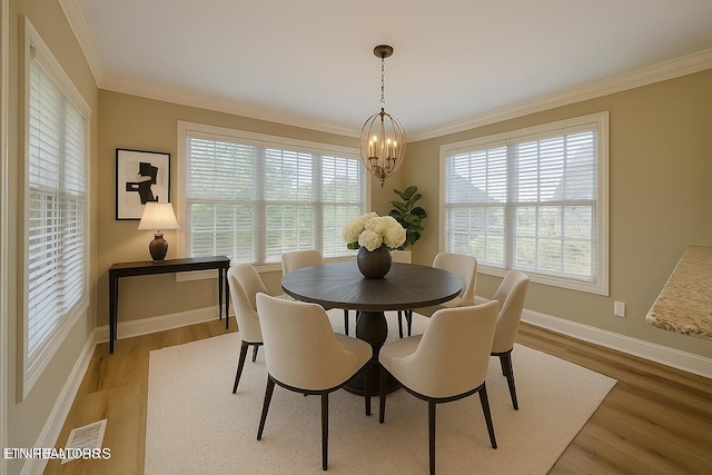 12139 Inglecrest Ln, Knoxville, TN 37934 - dining room with a chandelier, wood finished floors, crown molding, and baseboards
