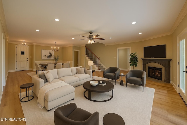 12139 Inglecrest Ln, Knoxville, TN 37934 - living area with ornamental molding, light wood finished floors, a warm lit fireplace, recessed lighting, and baseboards