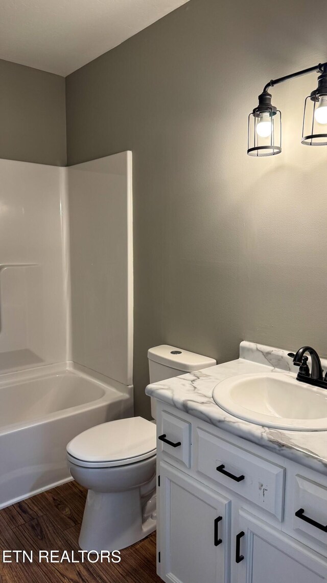 2315 Pine Grove Rd, Winfield, TN 37892 - full bath with toilet, washtub / shower combination, vanity, and wood finished floors