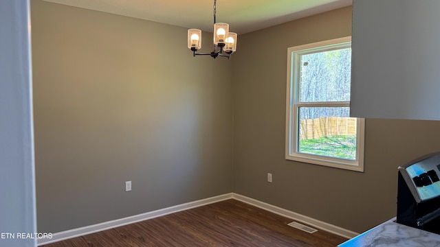 2315 Pine Grove Rd, Winfield, TN 37892 - unfurnished dining area with baseboards, a notable chandelier, dark wood-type flooring, and visible vents