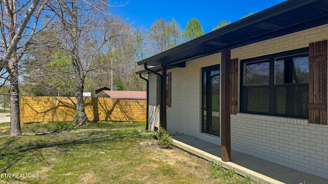 2315 Pine Grove Rd, Winfield, TN 37892 - view of side of home with brick siding, fence, and a yard