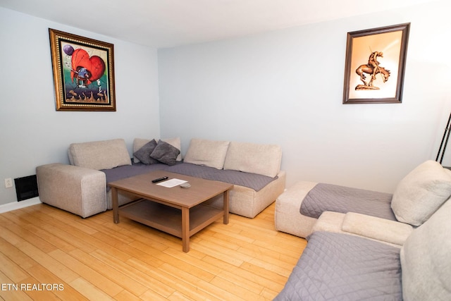 living room featuring light wood-type flooring and baseboards