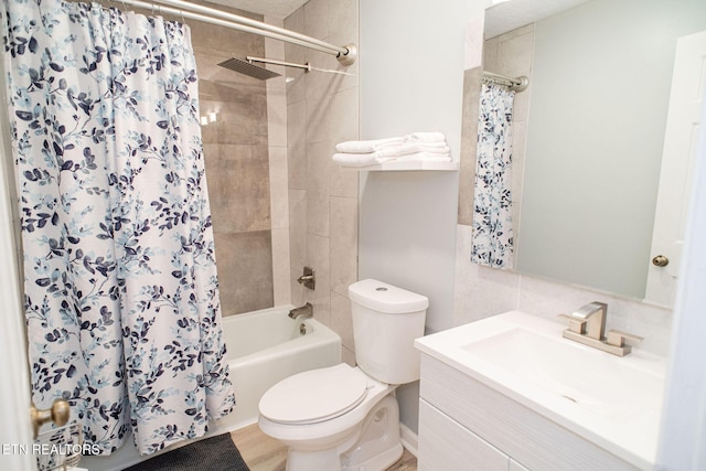 bathroom with vanity, toilet, and shower / tub combo