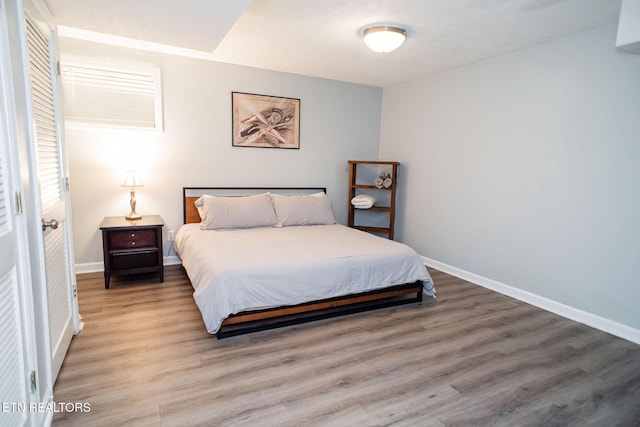 bedroom featuring baseboards and light wood-type flooring
