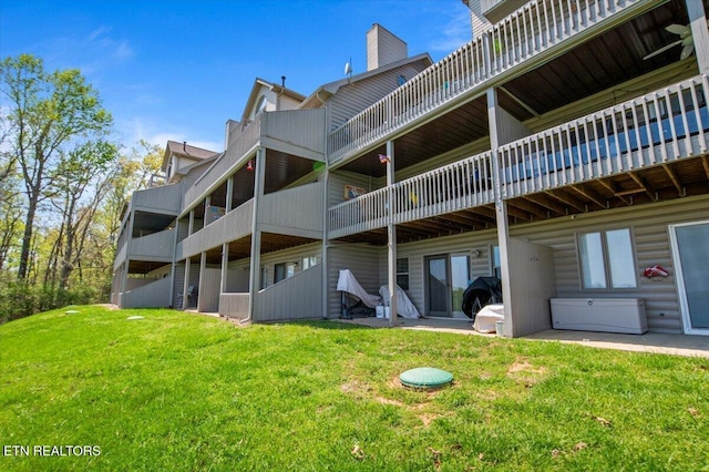 470 Deerfield Lndg Unit 5, Lafollette, TN 37766 - rear view of house featuring a lawn and a chimney