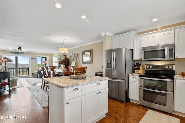 470 Deerfield Lndg Unit 5, Lafollette, TN 37766 - kitchen featuring stainless steel appliances, white cabinets, ornamental molding, dark wood-type flooring, and a kitchen island