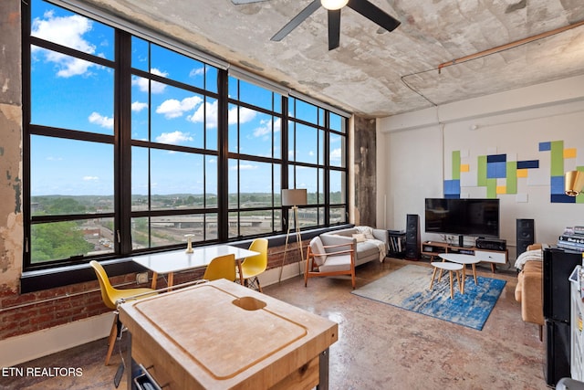 living area featuring concrete floors and ceiling fan