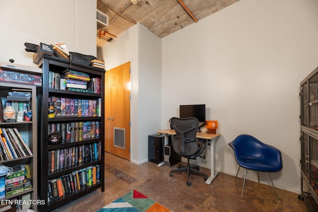 office space featuring concrete floors, visible vents, and baseboards
