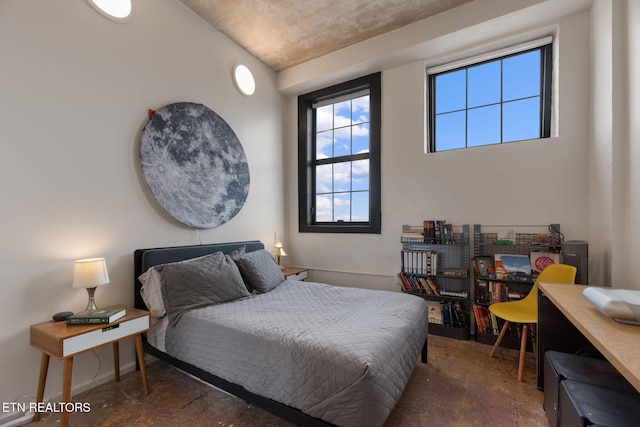 bedroom featuring concrete flooring