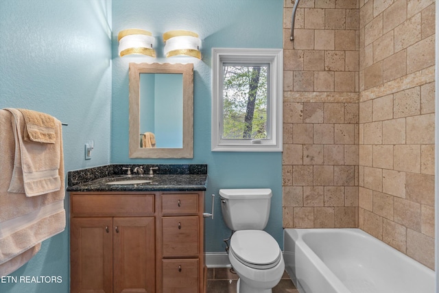 full bathroom featuring toilet, vanity, and baseboards