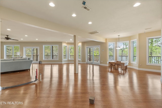 living area featuring recessed lighting, wood finished floors, visible vents, and baseboards