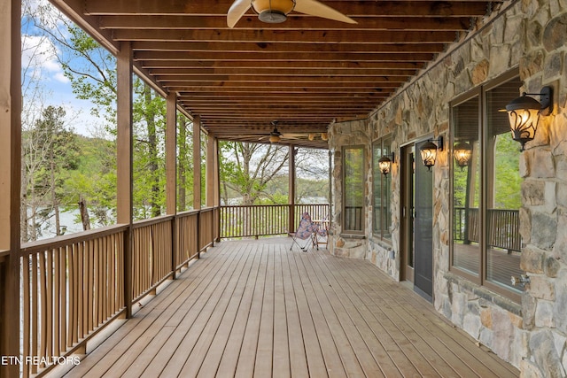 wooden deck with a ceiling fan