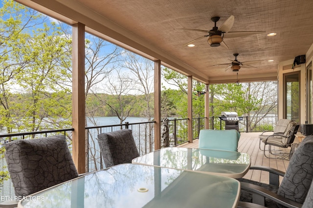 exterior space with a ceiling fan, outdoor dining space, and a water view