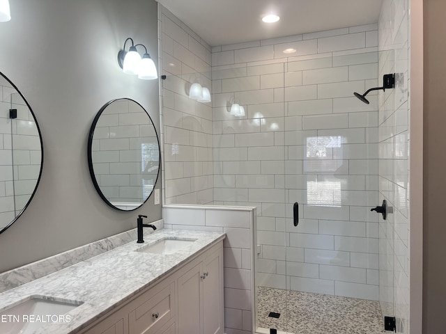 full bath with recessed lighting, double vanity, a shower stall, and a sink