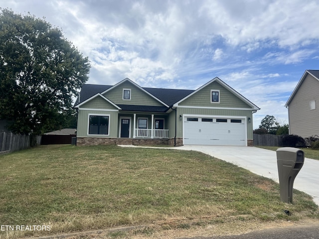 craftsman inspired home with driveway, fence, a porch, a front yard, and a garage